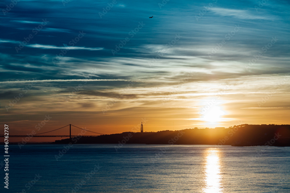 View of a bridge in the city of Lisbon, in Portugal, at sunset. Tourism and travel concept. View of a bridge in the city of Lisbon, in Portugal, at sunset. Tourism and travel concept.