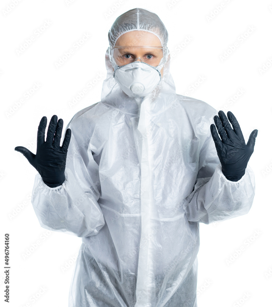 A man in a protective suit, mask and glasses. physician, specialist in infectious diseases, forensic expert, epidemiologist put on styry gloves and is ready to go. Covid-19 disease, epidemic. isolated A man in a protective suit, mask and glasses. physician, specialist in infectious diseases, forensic expert, epidemiologist put on styry gloves and is ready to go. Covid-19 disease, epidemic. isolated