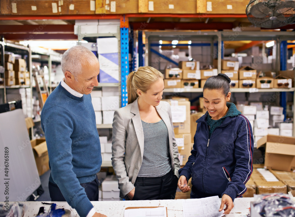 Last minute order revisions. Shot of managers at work supervising a shipping and distribution business. Last minute order revisions. Shot of managers at work supervising a shipping and distribution business.