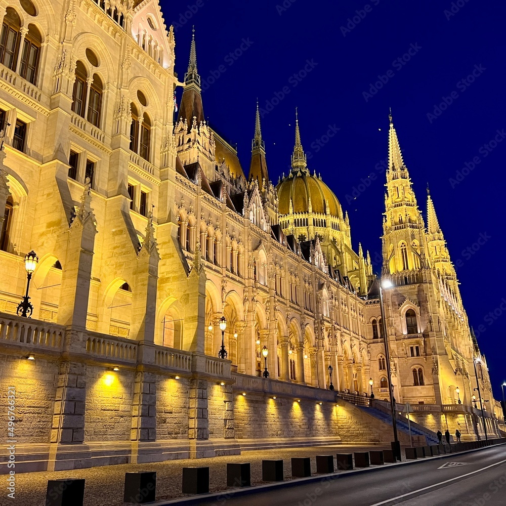 Hungarian Parliament building in Budapest night photography of bright yellow illuminated walls and dark blue sky near the Danube River. High quality 4k footage 03.04.22 Budapest, Hungary