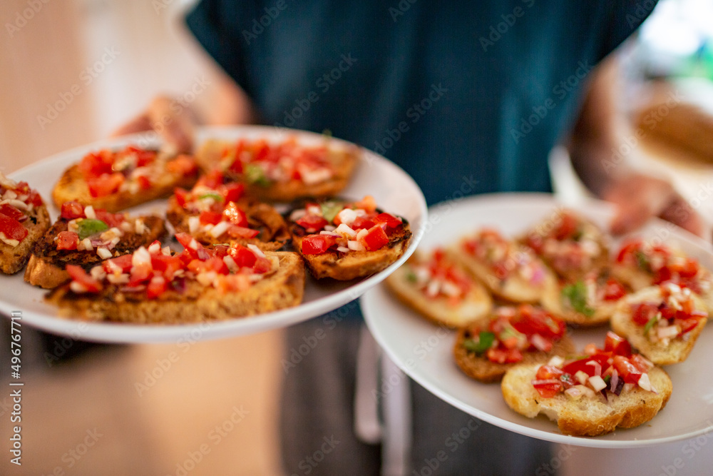 Girl serving fresh bruschetta in plates Girl serving fresh bruschetta in plates