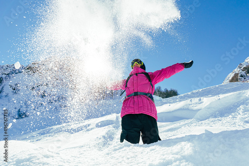 Man throwing snow enjoying sunny day