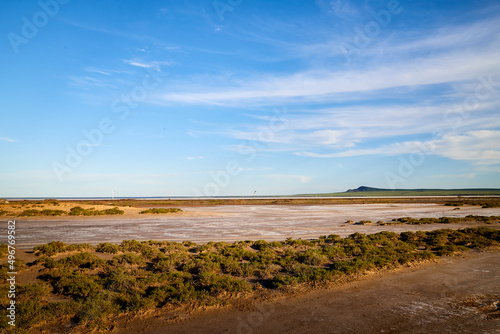 Landscape with lake  steppe  grass and blue sky with white clouds in autumn or summer evening