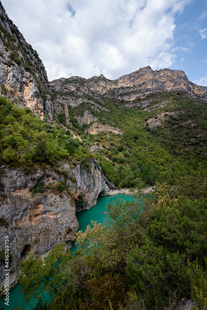 Deep turquoise river at the bottom of a vertical canyon