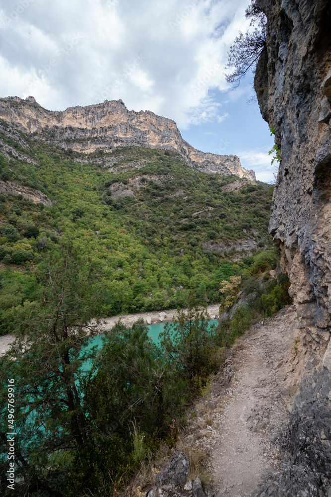 Deep turquoise river at the bottom of a vertical canyon Deep turquoise river at the bottom of a vertical canyon