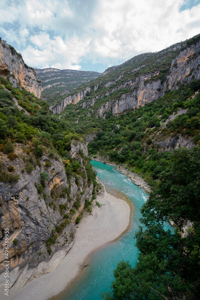 Deep turquoise river at the bottom of a vertical canyon