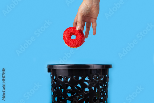 The donut is thrown into the trash can.