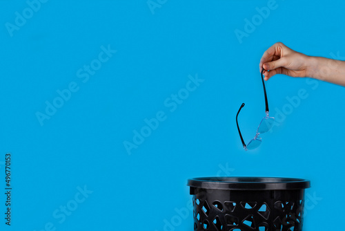 Glasses are thrown into the trash can.