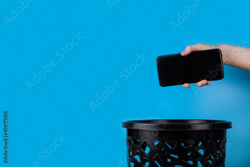 The smartphone is thrown into the trash for disposal