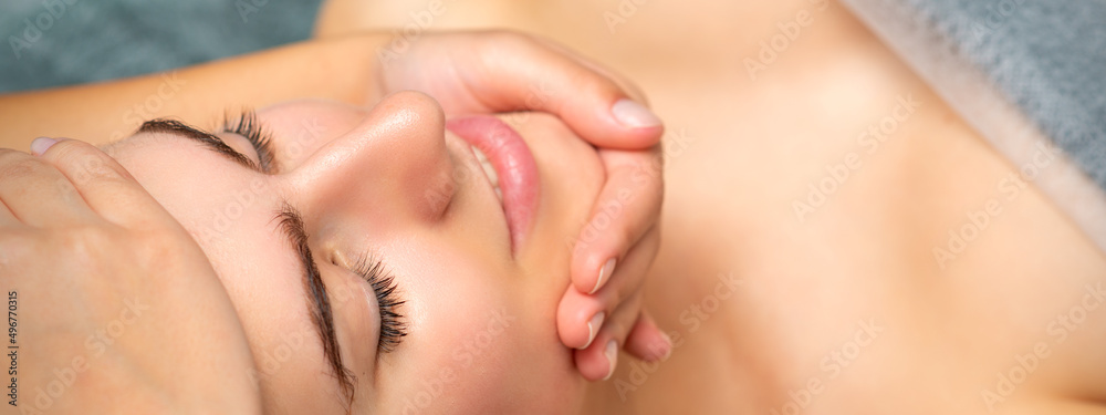 Face massage of detox therapy for the pretty female patient at spa salon