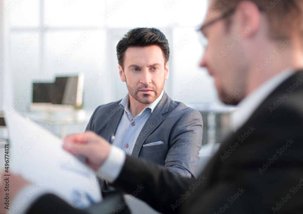 close up. two employees discussing business documents close up. two employees discussing business documents