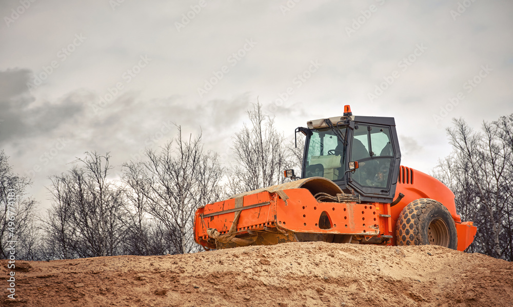 Soil compactor with smooth drum. Soil compactor for leveling ground, road construction. Road compaction heavy duty equipment at construction site. Vibration road roller during leveling and compacting Soil compactor with smooth drum. Soil compactor for leveling ground, road construction. Road compaction heavy duty equipment at construction site. Vibration road roller during leveling and compacting