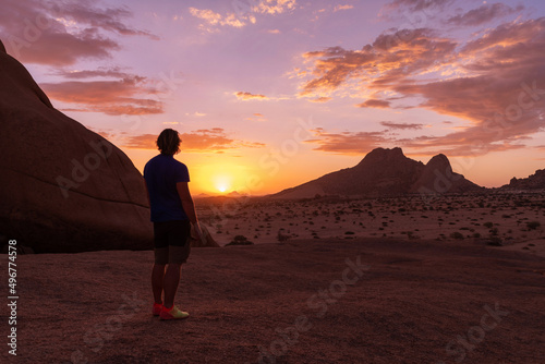 The man is staying and looking for a sunset in Namibia.