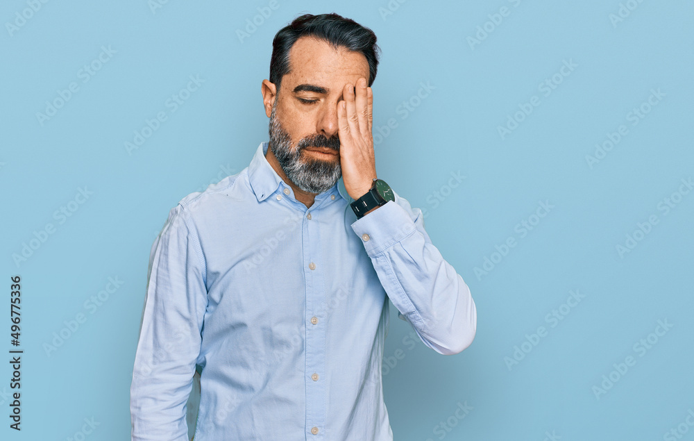 Middle aged man with beard wearing business shirt yawning tired covering half face, eye and mouth with hand. face hurts in pain. Middle aged man with beard wearing business shirt yawning tired covering half face, eye and mouth with hand. face hurts in pain.