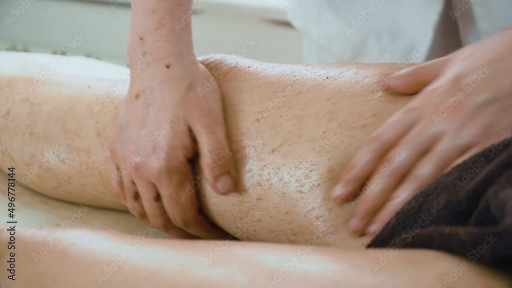 Masseuse massages knees and legs of beauty woman with young skin in spa salon close up. Concept of body care and alternative medicine Masseuse massages knees and legs of beauty woman with young skin in spa salon close up. Concept of body care and alternative medicine