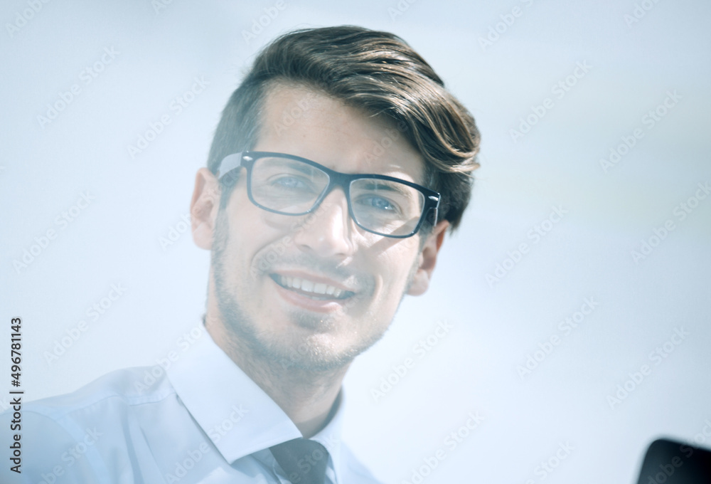 close up.successful young businessman sitting at his Desk close up.successful young businessman sitting at his Desk