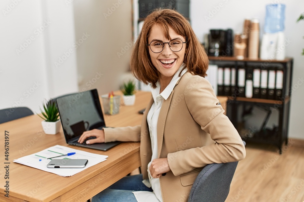 Young caucasian businesswoman smiling happy working at the office.
