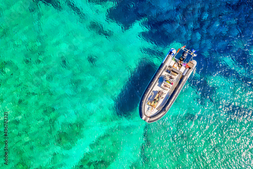 Aerial drone view of a boat with turquoise water. Ionian sea, Kefalonia Island, Greece. © Nikolay N. Antonov
