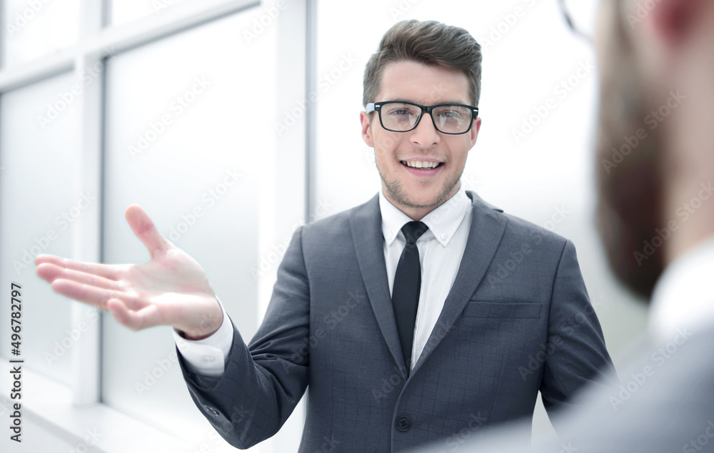 young businessman talking standing in the office young businessman talking standing in the office