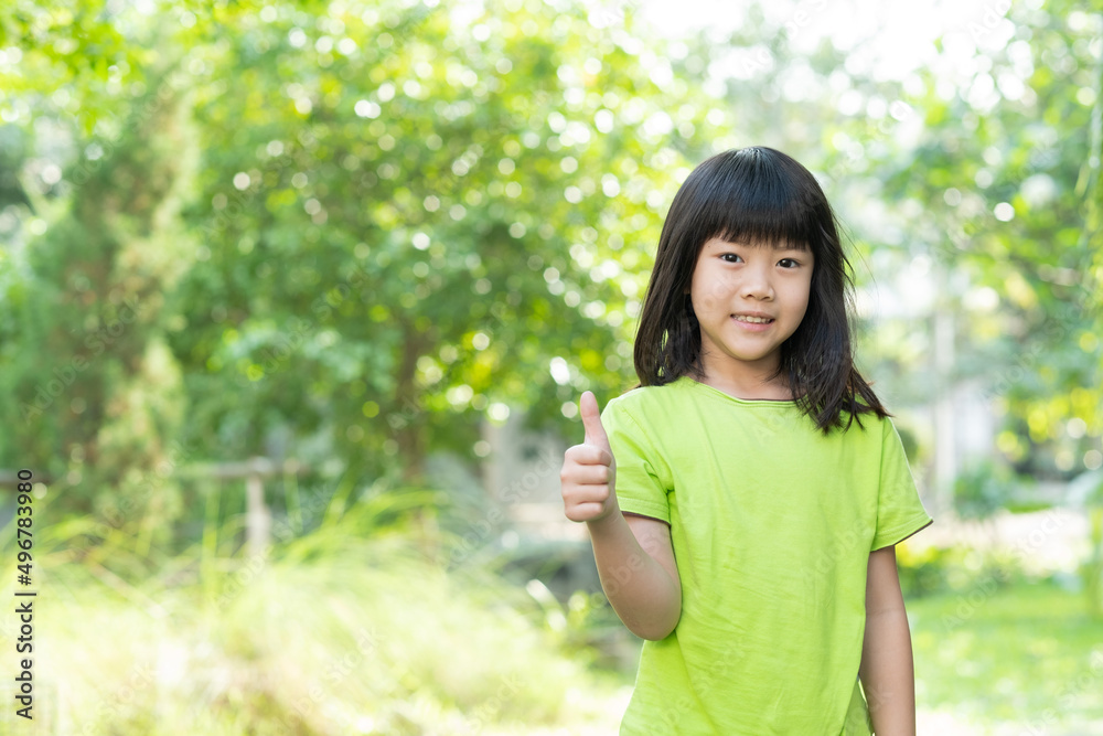portrait asian kid, child enjoy and happy, the girl is smiling, thumbs up kid