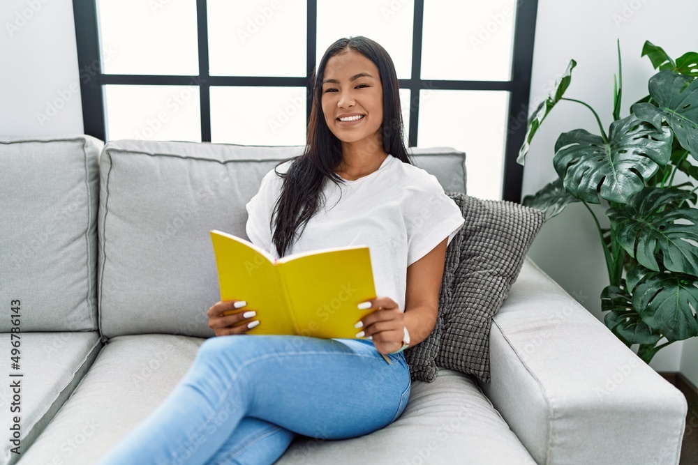 Young latin woman smiling confident reading book at home Young latin woman smiling confident reading book at home