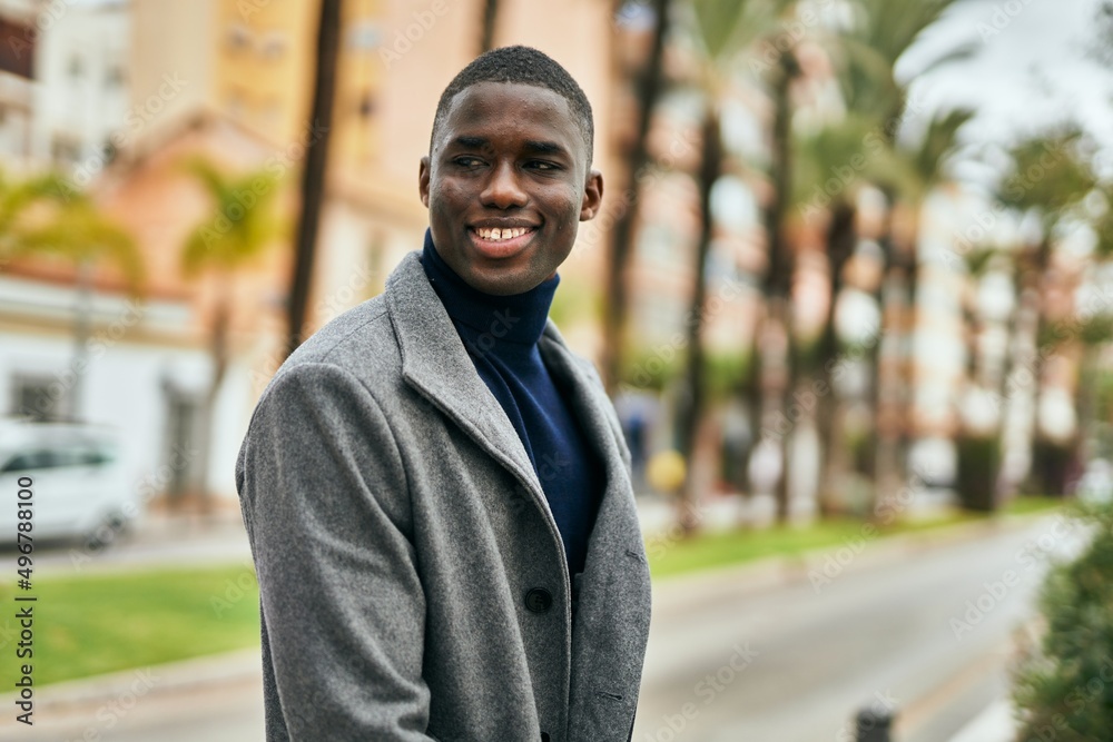 Fototapeta premium Young african american man smiling happy standing at the city