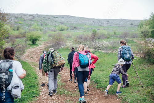 people travelers hike along a forest road