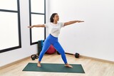 Young african american woman smiling confident training yoga at sport center