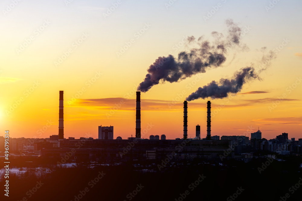 Factory pipes thermal power plants with thick white smoke from heat energy nuclear plant polluting environment. Selective focus