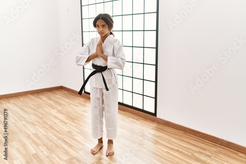 African american girl wearing kimono training karate at sport center