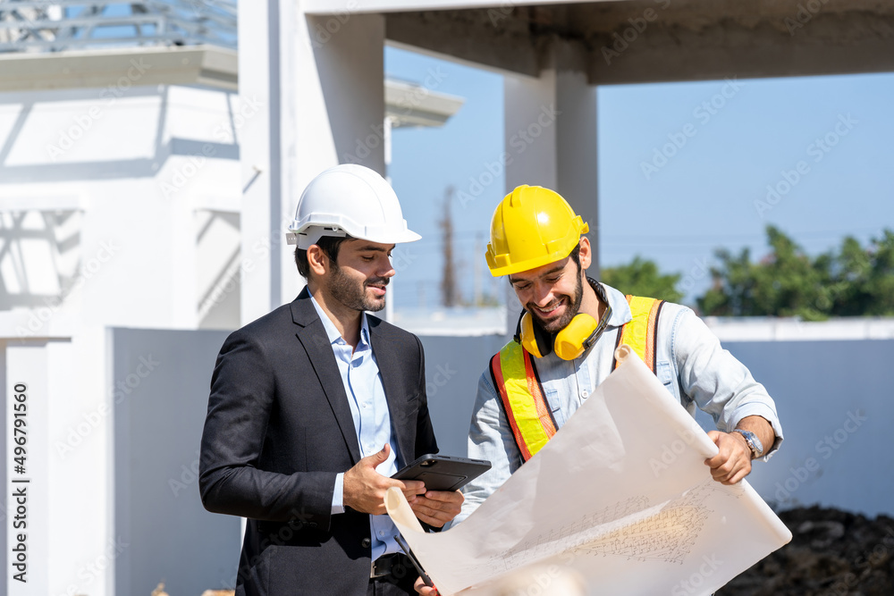 Engineer and businessman planning new residential subdivision home building in construction site. Engineer and businessman planning new residential subdivision home building in construction site.