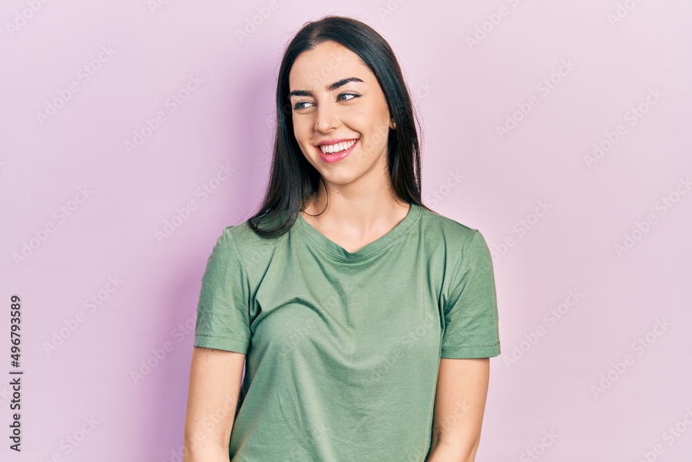 Beautiful woman with blue eyes wearing casual t shirt looking away to side with smile on face, natural expression. laughing confident. Beautiful woman with blue eyes wearing casual t shirt looking away to side with smile on face, natural expression. laughing confident.