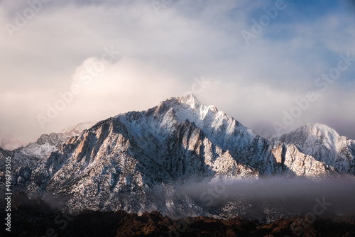 Beautiful view of snow covered Alabama hills with clouds on top photo