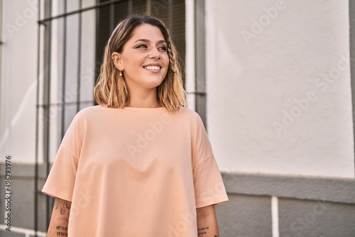 Young hispanic woman smiling confident at street