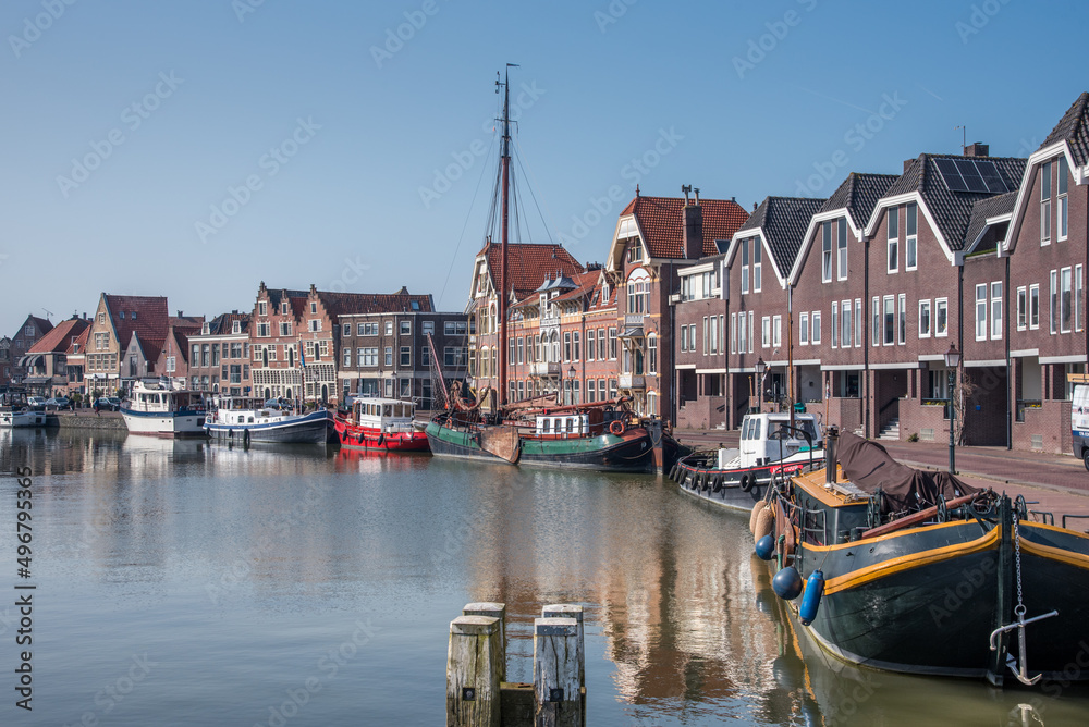 Hoorn, Netherlands, March 2022. The harbor of Hoorn with the old boats and historic facades.