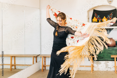 Happy flamenco woman dancer moving the manila shawl