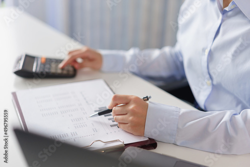 Business concept, Businesswoman reading financial data on document and calculate cost of project