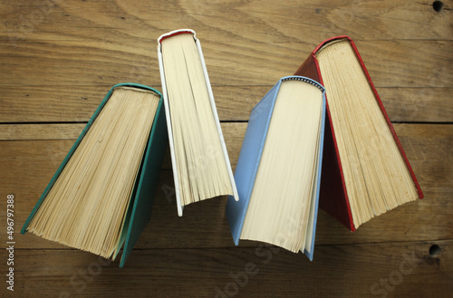 Four old books on wooden background table