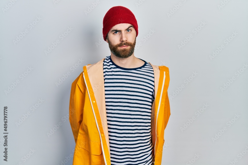 Caucasian man with beard wearing yellow raincoat skeptic and nervous, frowning upset because of problem. negative person. Caucasian man with beard wearing yellow raincoat skeptic and nervous, frowning upset because of problem. negative person.