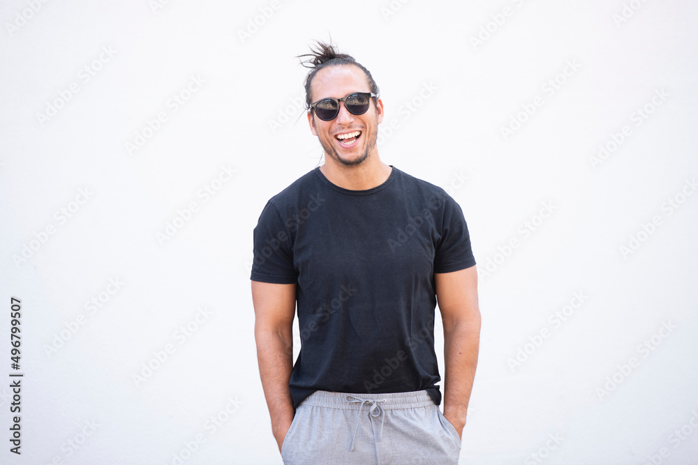 Cheerful handsome man with hair bun and sunglasses Cheerful handsome man with hair bun and sunglasses