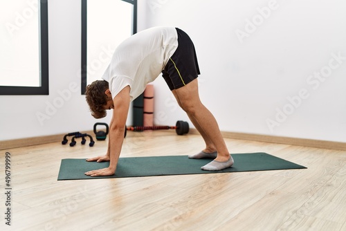 Young arab man stretching at sport center