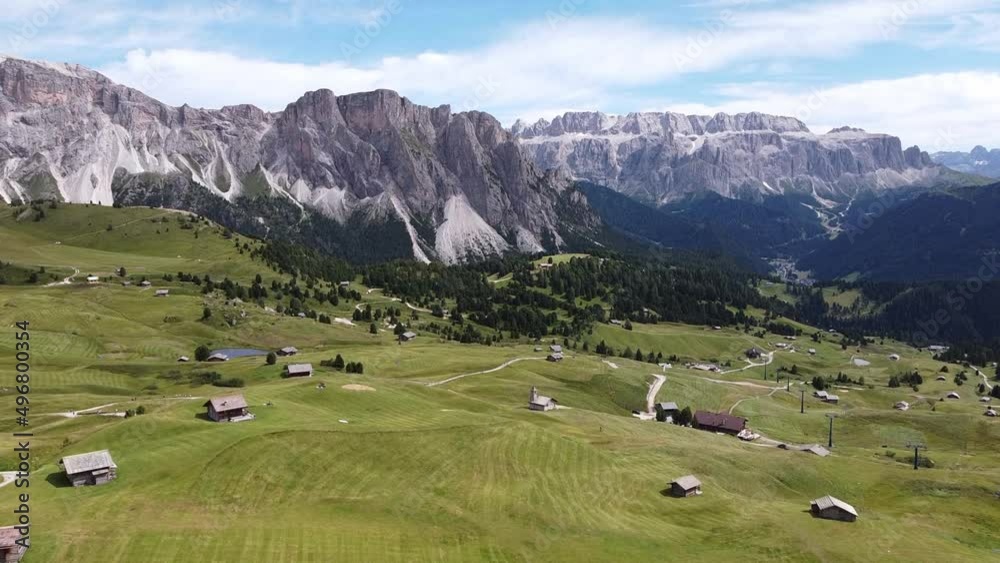 Seceda and Val Gardena Valley at South Tyrol, Italian Alps, Dolomites, Italy - Aerial Drone View of Green Valley, Cabins and High Mountains Seceda and Val Gardena Valley at South Tyrol, Italian Alps, Dolomites, Italy - Aerial Drone View of Green Valley, Cabins and High Mountains