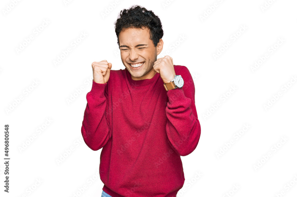 Young handsome man wearing casual clothes excited for success with arms raised and eyes closed celebrating victory smiling. winner concept. Young handsome man wearing casual clothes excited for success with arms raised and eyes closed celebrating victory smiling. winner concept.