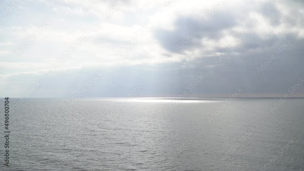 Gray calm sea in cloudy weather. Marine background, top view Gray calm sea in cloudy weather. Marine background, top view