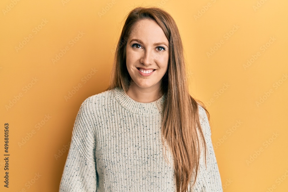 Young blonde woman wearing casual winter sweater with a happy and cool smile on face. lucky person. Young blonde woman wearing casual winter sweater with a happy and cool smile on face. lucky person.