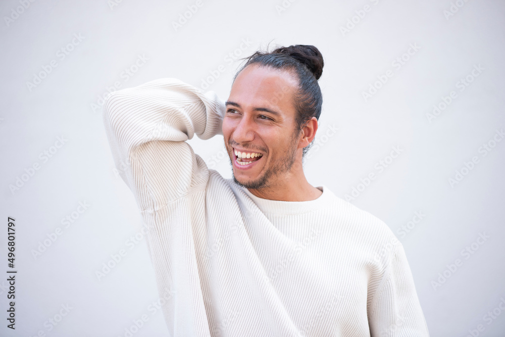 Portrait of cheerful man with hand behind head over white background