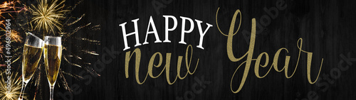 Happy new year - Silvester background banner panorama long- sparklers, golden firework, champagne glasses and bokeh lights on rustic wooden texture, with space for text