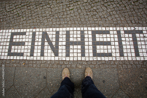 Footprint of the former Berlin Wall built in 1961. After it was demolished in 1989 the original line has been memorialized by mosaic or brass plaques. Einheit - Unity.