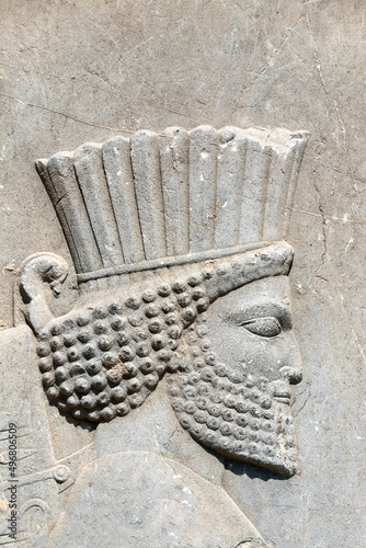 Bas-relief with face of assyrian warrior on ancient wall, Persepolis, Iran