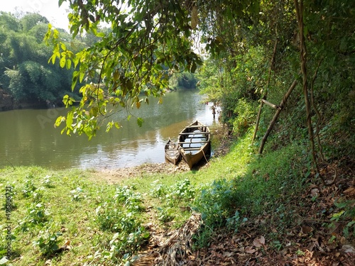 Fototapeta Naklejka Na Ścianę i Meble -  a small and big wooden boat abandoned in the bank of the river , a view from kerala